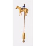 Equestrian interest: a novelty enamel and 9ct gold stick pin, modelled in the form of a horse and