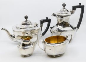 A George V silver four piece tea service comprising teapot, hot water jug, sugar bowl and milk