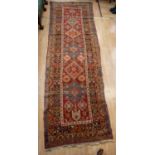 A South West Persian (Qashqa) wool runner, red ground decorated with figures, birds, crabs, animals,