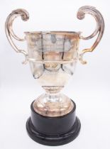 Scottish Interest: a George V silver two handled cup, scrolling handles with mid rib, on raised