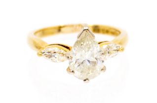 A diamond and 18ct yellow gold three stone ring, comprising a central pear cut diamond, approx 2.0