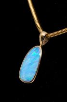 An opal and 18ct gold pendant and chain, comprising an irregular solid opal with green play of