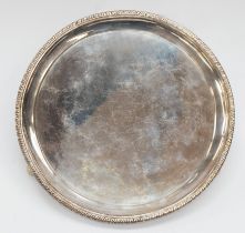 A George III Scottish silver circular waiter, gadroon border on three scroll and ball supports,