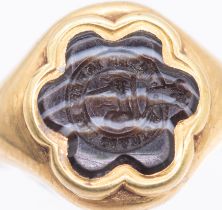 An early 19th century hardstone gold seal signet ring, comprising a six petaled flower motif of