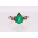 An emerald and diamond 18ct gold ring, comprising a pear cut emerald, measuring approx 1.86 carat,