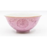 A Chinese pink ground porcelain bowl, Qianlong seal mark but later, with puce painted details,