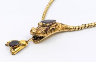 A Victorian gold and garnet set serpent necklace, comprising a graduated fancy link chain, with a