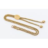 A Victorian 9ct gold lariat necklace, comprising a faceted belcher link chain with an adjustable