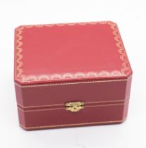 Cartier: a leather bound red watch box with cushion to insert, size 15 x 13 x 9cm, clasp to front