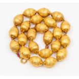 An antique gold hollow bead necklace, comprising Indian style beads with gadrooned decoration,