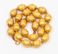 An antique gold hollow bead necklace, comprising Indian style beads with gadrooned decoration,