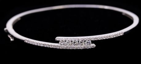 A diamond and 14ct white gold cross over bangle, comprising five round brilliant cut channel set