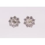 A pair of diamond and 18ct white gold flower cluster studs, each earring comprising an old