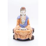 A Chinese porcelain figure of Avalokiteshvara, 20th Century, seated in meditation, eurobed, a tiny