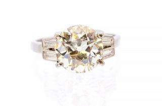 An Art Deco style diamond and  platinum solitaire ring, comprising an old European cut diamond,