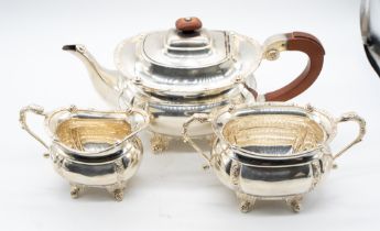 An Arts & Crafts silver three piece Celtic Revival tea service comprising teapot, two handled