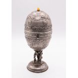 A Continental white metal (untested) egg shaped engine turned music box, the cover and body with