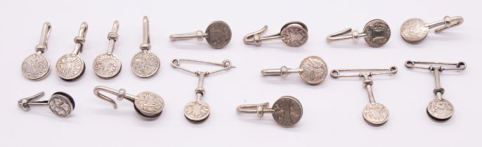 A collection of fifteen Edwardian silver circular napkin clips, various engraved patterns, some with