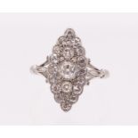 An early 20th century diamond and 18ct white gold ring, comprising a marquise shaped count set to