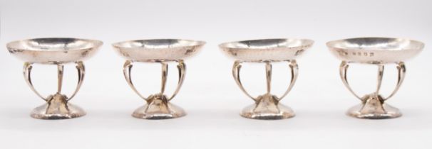 A set of four Scottish Arts & Crafts silver bon bon dishes, the planished (hammered) circular dishes