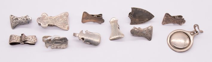 A collection of eleven early 20th Century silver napkin clips, various shapes (circular, shield
