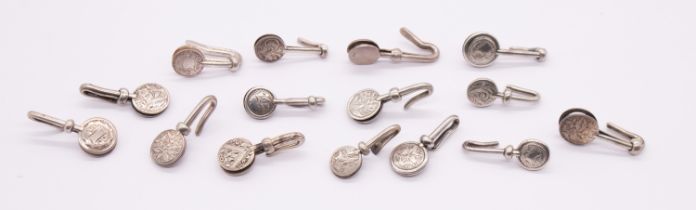 A collection of fifteen early 20th Century English silver circular napkin clips, various engraved