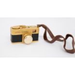 Steky: A Golden Steky, subminiature camera, Serial Number 1138. With attached Riken Stekinar 1:3.