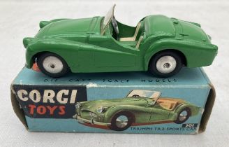 Corgi: A boxed Corgi Toys, Triumph TR2 in dark green, Reference 301. Vehicle in very good original