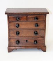 A miniature Edwardian mahogany chest of two short and three graduated long drawers with ebonised