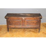 An 18th century oak two panel coffer, on pegged stile supports, 115cm wide