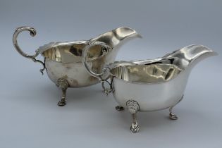 J B Chatterley and Sons, a pair of George V silver sauce boats, each with leaf capped scroll handle,
