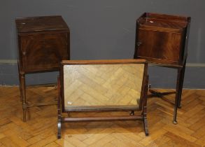 Two early 20th century mahogany pot cupboards, together with an oak toilet mirror, 66cm wide (3)
