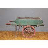 An Edwardian painted street vendors barrow/handcart, raised on iron spoked and iron clad wheels,