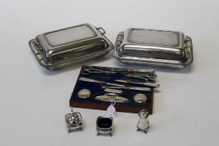 A collection of silver plate featuring two lidded serving dishes retailed by Harrods, a plated cruet