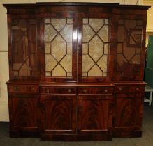 A George III style mahogany breakfront bookcase, the moulded cornice over astragal glazed panel