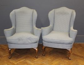 A pair of beech framed Queen Anne style wing armchairs upholstered in light patterned weave