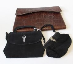 A collection of 1930's handbags featuring an alligator skin handmade clutch bag, a small scallop