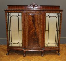 An early 20th century mahogany side cabinet, the near full length central panel door flanked to each