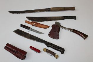 A collection of edged weapons and similar items, including Columbian and other machete, Estwing