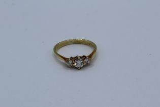 An 18ct three stone diamond ring, total diamond weight approximately 0.39ct