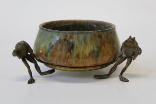 A 19th century Continental streaked glazed porcelain bowl with three cast gilt metal supports,