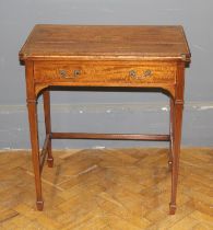 An Edwardian satinwood lady's writing table, the hinged top enclosing pen rests, provision for