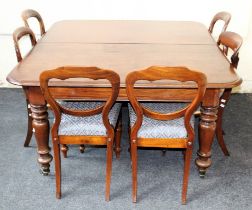 A late Victorian mahogany drawleaf dining table, raised on baluster turned legs and brass castors,