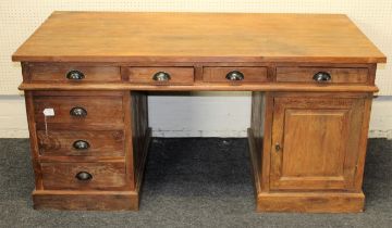 An oak and pine kneehole pedestal desk of large size fitted with drawers and cupboards, w161cm