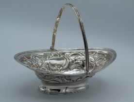 Henry Chawner, a George III silver sweet basket, with reeded swing handle, embossed decoration, on