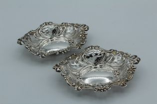 Hilliard and Thomason, a pair of Victorian silver bon bon dishes of pierced, oval organic form.