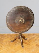 A George III mahogany tripod table, the circular snap top painted with floral garlands and trophies,