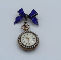 A yellow metal enamel ladies pocket watch featuring enamelled pansy and seed pearls. Suspended