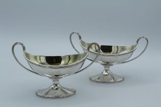 John Ermes, a pair of George III silver twin handled navette form pedestal salts, London 1799, 9 x
