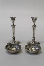 A pair of columnar loaded candlesticks along with a pair of pierced work silver bonbon dishes,